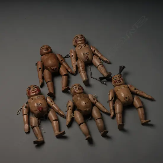Five Asian articulated wooden puppets,
